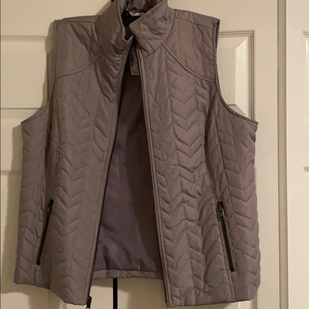 A zip up grey coat vest